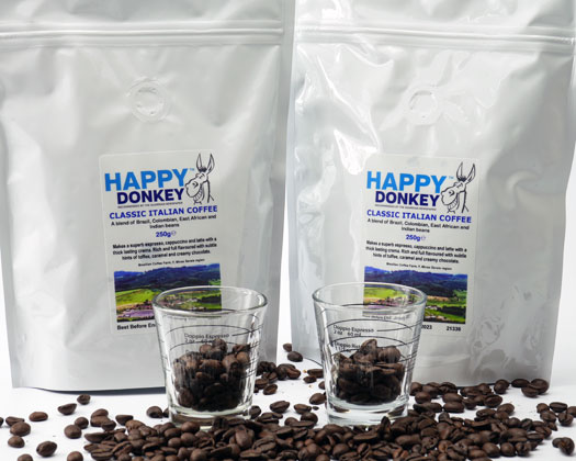 Image displaying Happy Donkey coffee beans and shot glasses.